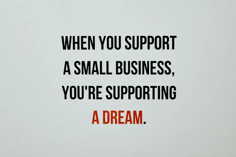 Sign that reads when you support small businesses, you're supporting a dream